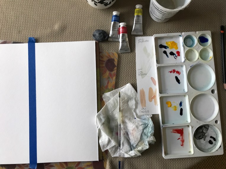 Mixing watercolor paint to paint the ocean