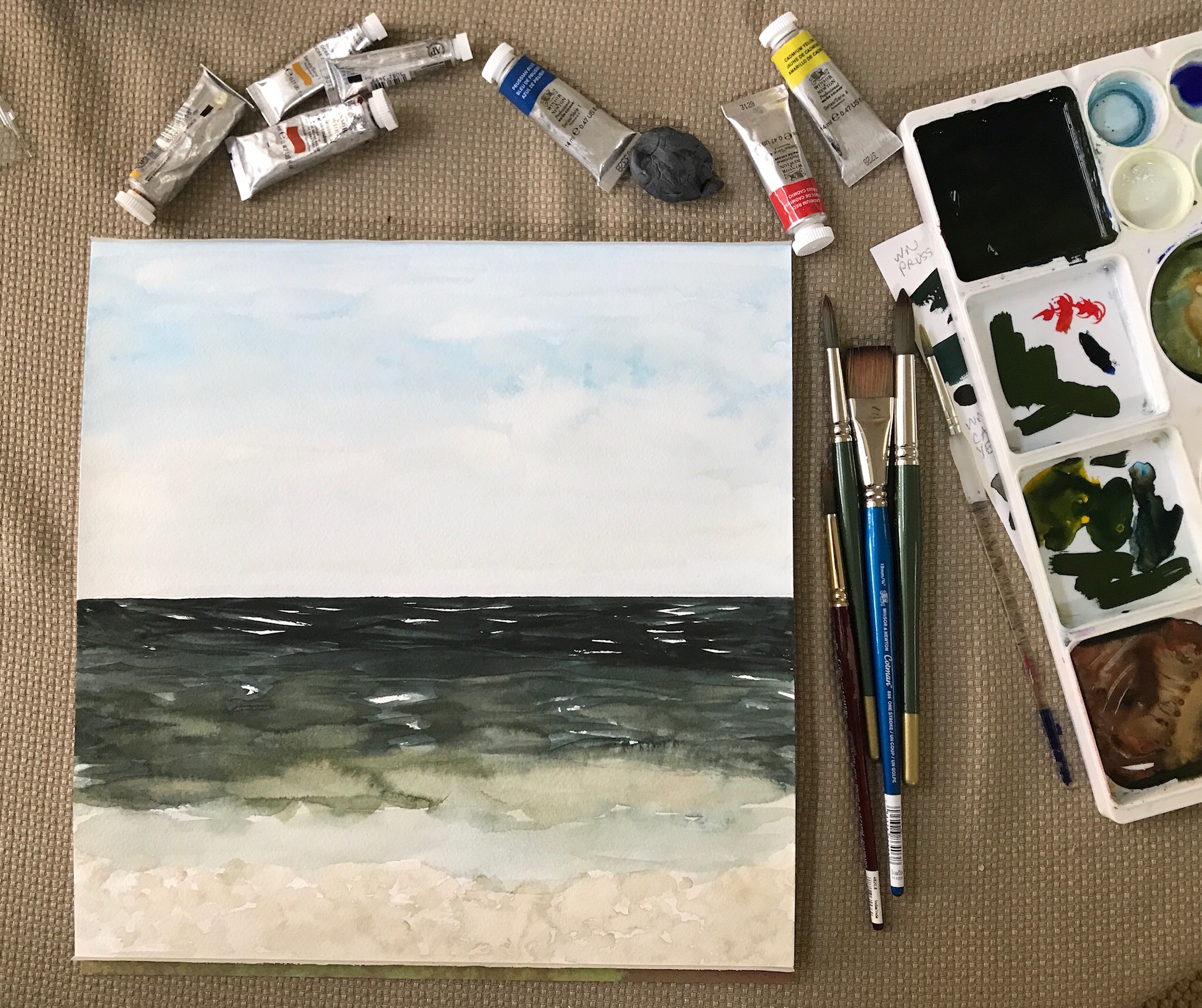 Mixing watercolor paint to paint the ocean